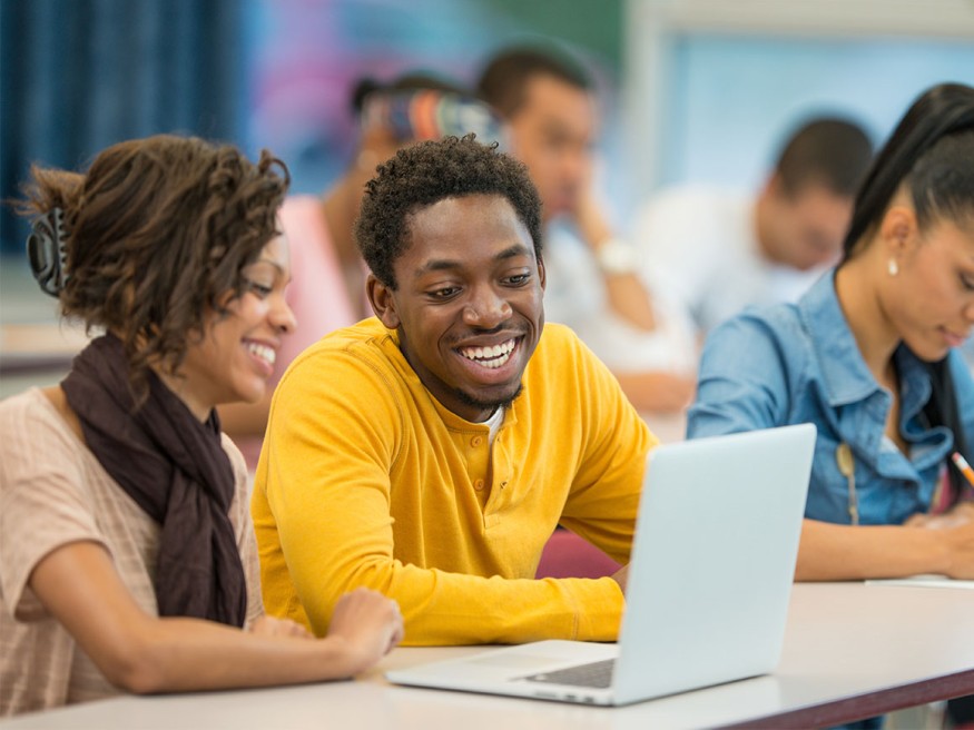 Students looking at something on a laptop computer